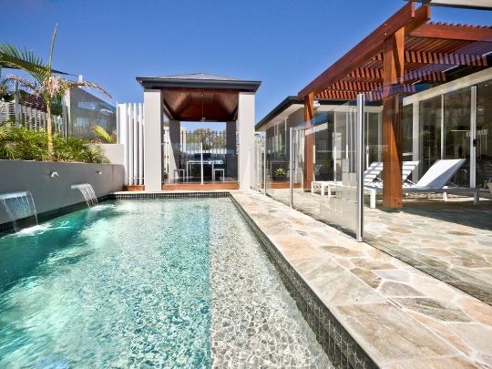 contemporary pool area with glass pool enclosure | Dandenong Fencing Pros